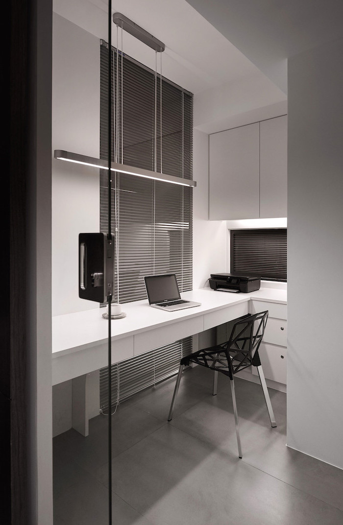 white wall cupboards and drawers, grey blinds, black geometrical chair, office pictures