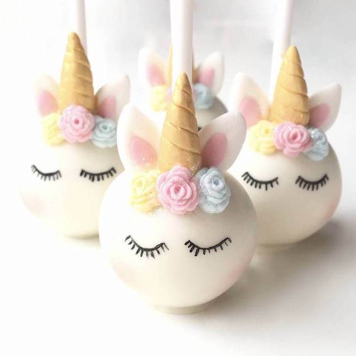 white fondant cake pops, gold horns, how to make a unicorn cake, blue pink and yellow roses