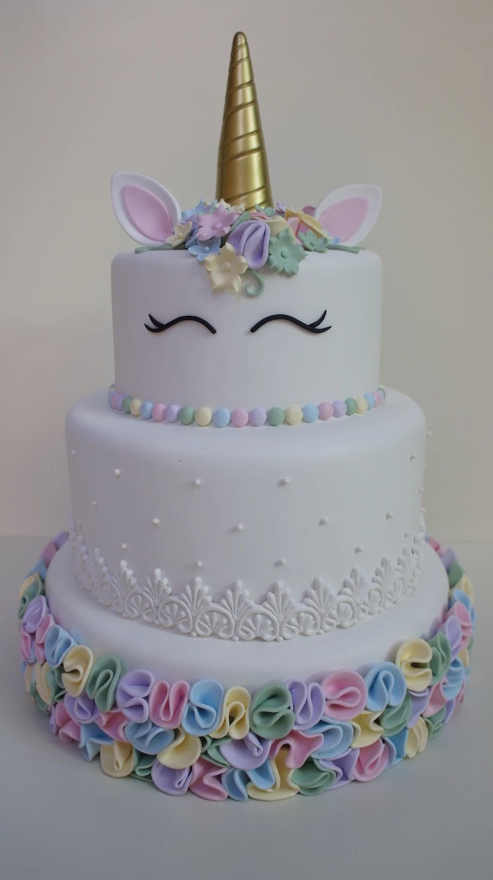 pink yellow green blue and purple roses on white fondant, unicorn cupcake cake, gold horn