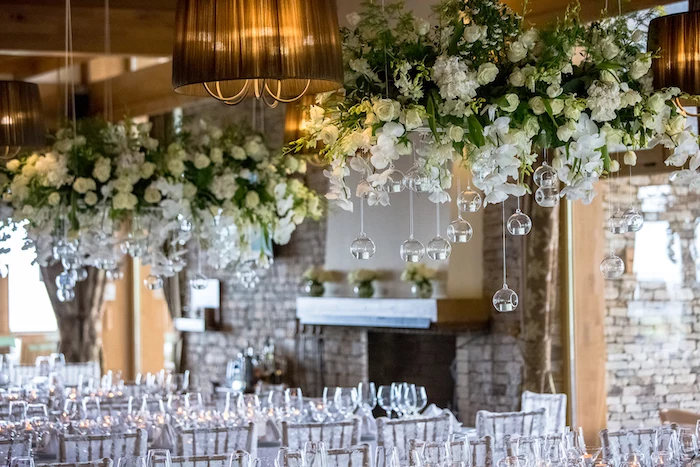 white roses hanging from the ceiling, white tulle on the chairs, wedding ideas for spring