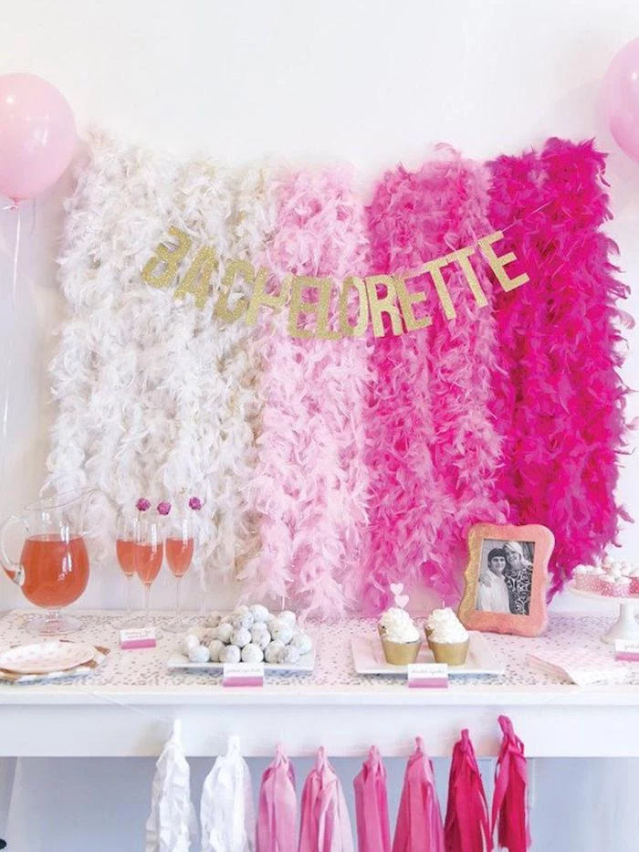 bachelorette glitter sign, fun bachelorette party ideas, shades of pink garlands, champagne flutes