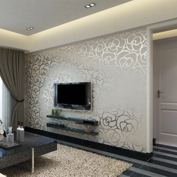 white and silver floral wallpaper, wallpaper accent wall, grey and black striped floor, black coffee table