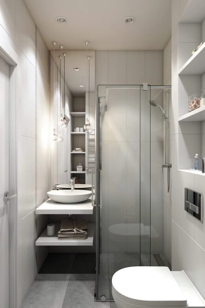 grey tiled walls and floor, bathroom wall ideas, glass shower door, large mirror, floating wooden shelves