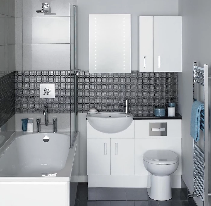 grey mosaic tiled walls, black tiled floor, bathroom wall ideas, white cabinets bathtub and toilet bowl