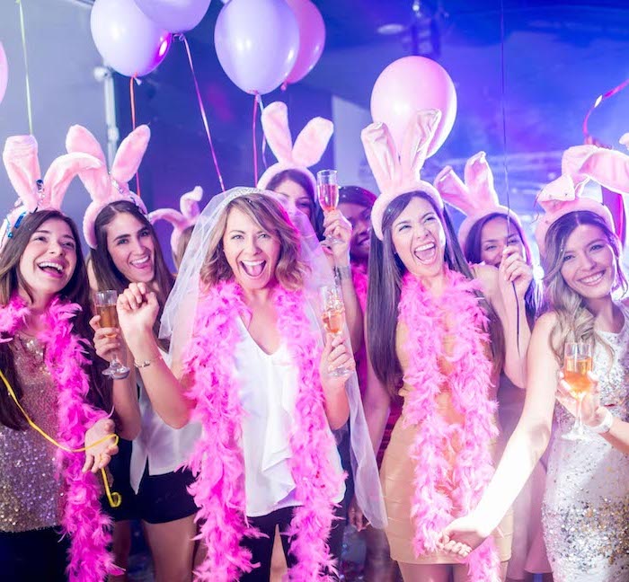 bunny ears on ladies, bachelorette party ideas, hot pink garlands, ladies having fun