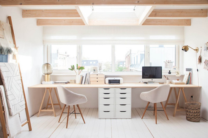 long wooden desk, white chairs, white drawers, lamp hanging from the wall, office design