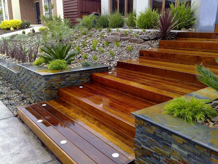 wooden staircase, simple front yard landscaping ideas with pictures, patches of rocks grass and bushes