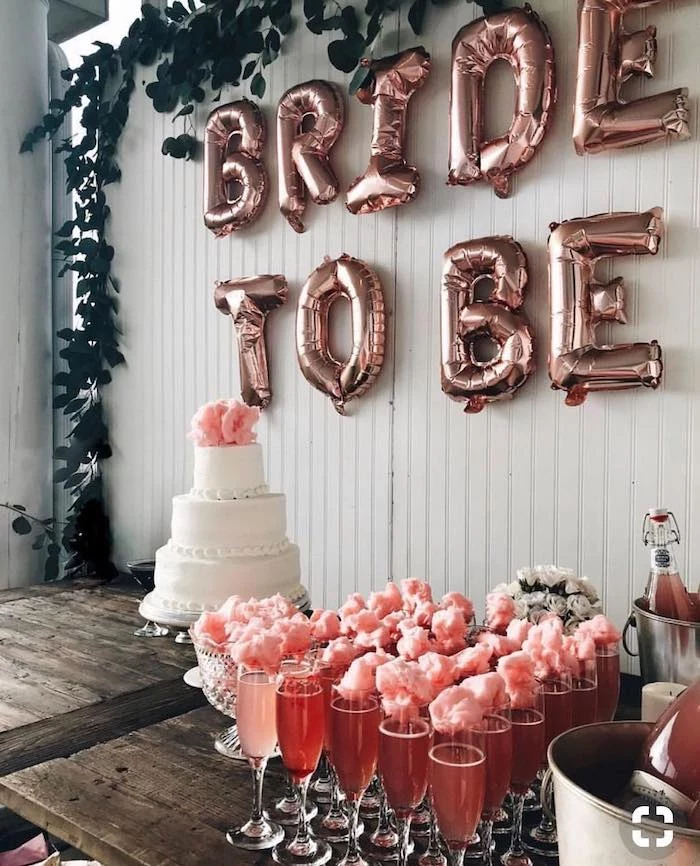 bride to be balloons, champagne flutes with cotton candy, fun bachelorette party ideas, three tier cake