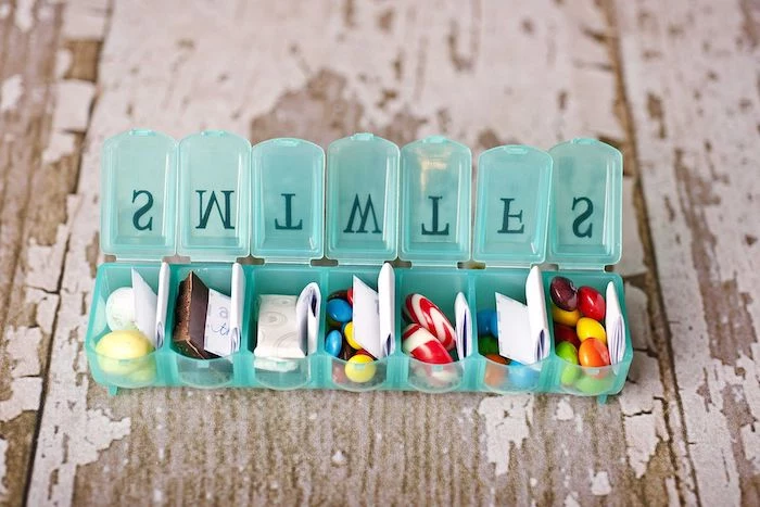 love messages written on a piece of paper, pill box filled with candy, creative valentine's day gifts for boyfriend