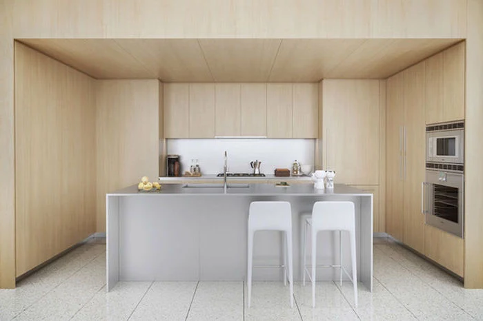 wooden walls and cabinets, grey stainless steel kitchen island, white stools, kitchen island decor