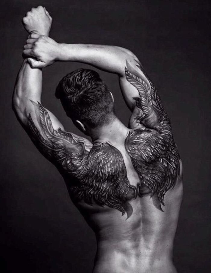 man stretching, angel wings, back tattoo, forearm tattoos, black background, brown hair