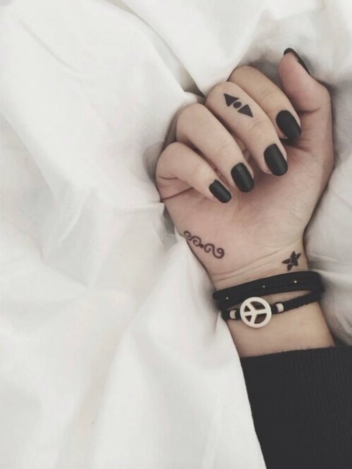 arrows and a dot, middle finger tattoo, ring finger tattoos, black matte nail polish, black bracelet