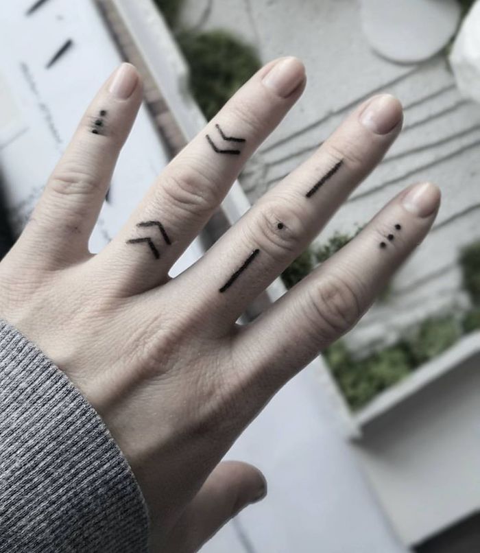 arrows lines and dots, many finger tattoos, ring finger tattoos, blurred background