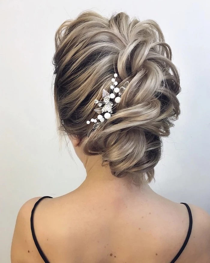 braided platinum blonde hair, in an updo, wedding hairstyle, small pearl hair accessory