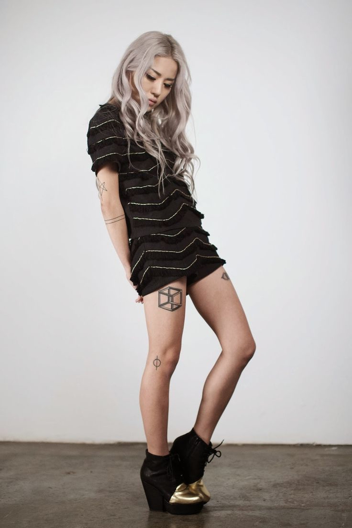 black dress and shoes, long platinum blonde hair, flower of life tattoo, 3d square thigh tattoo