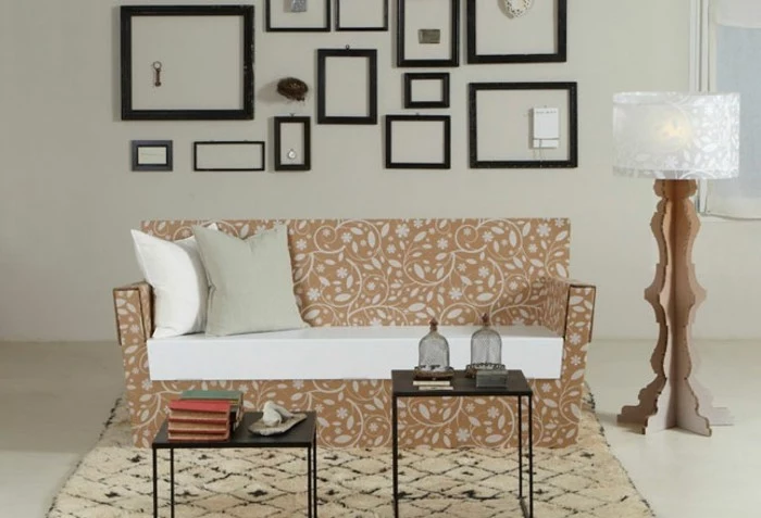 cardboard sofa, with white and grey pillows, cardboard lamp, cardboard furniture, small metal coffee tables