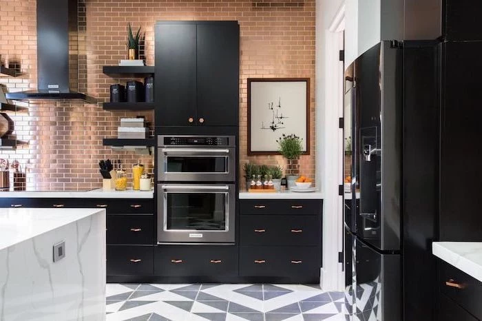 black matte cupboards and drawers, brass tiled wall, marble countertops, kitchen appliances