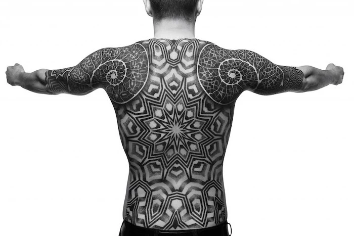 intricate black and white, whole back tattoo, man stretching his arms, white background, sleeve tattoos for men