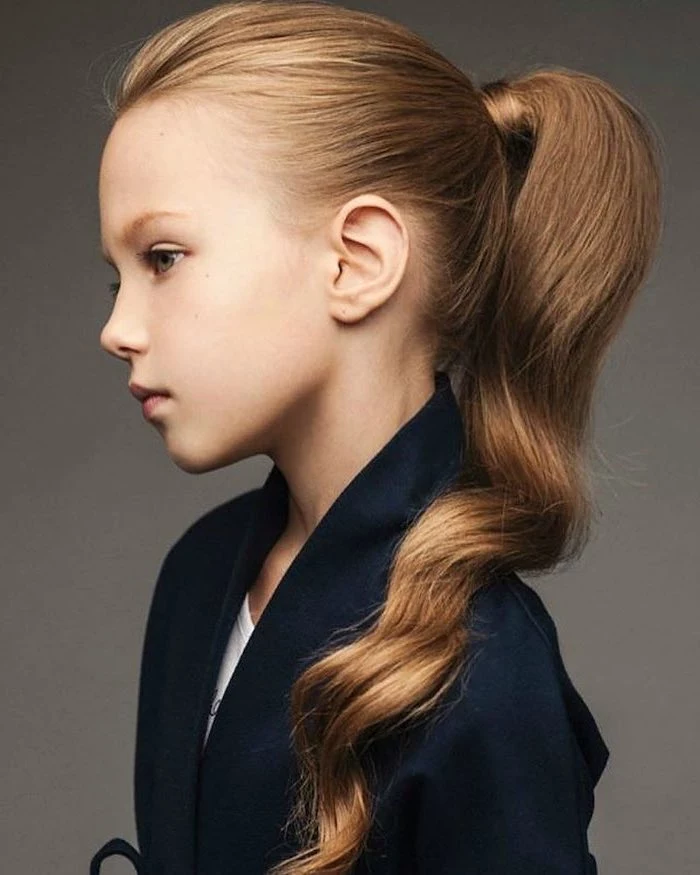 long wavy blonde hair, high ponytail, black blazer, grey background, little girl hairstyles