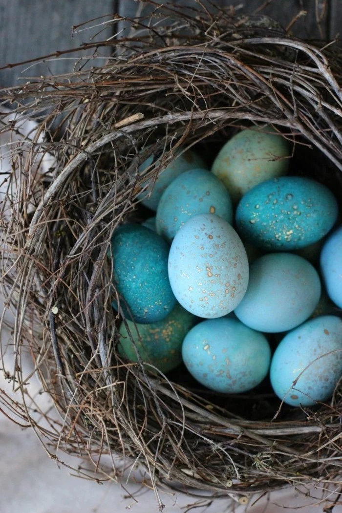 shades of blue eggs, with gold dots, in a wooden branches nest, easter egg designs, diy tutorial