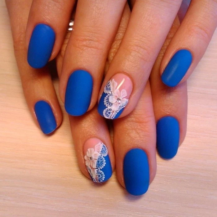 blue matte nail polish, easy nail designs, squoval nails, flowers drawn on two of the nails