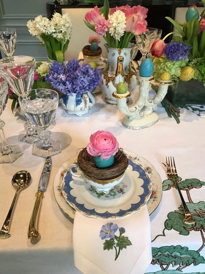 small flower bouquets, easter centerpieces, blue and white plate settings, with wine glasses