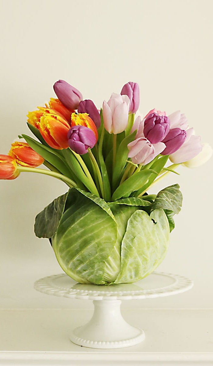 large bouquet of tulips, inside a cabbage, easter decorating ideas, on a cake stand