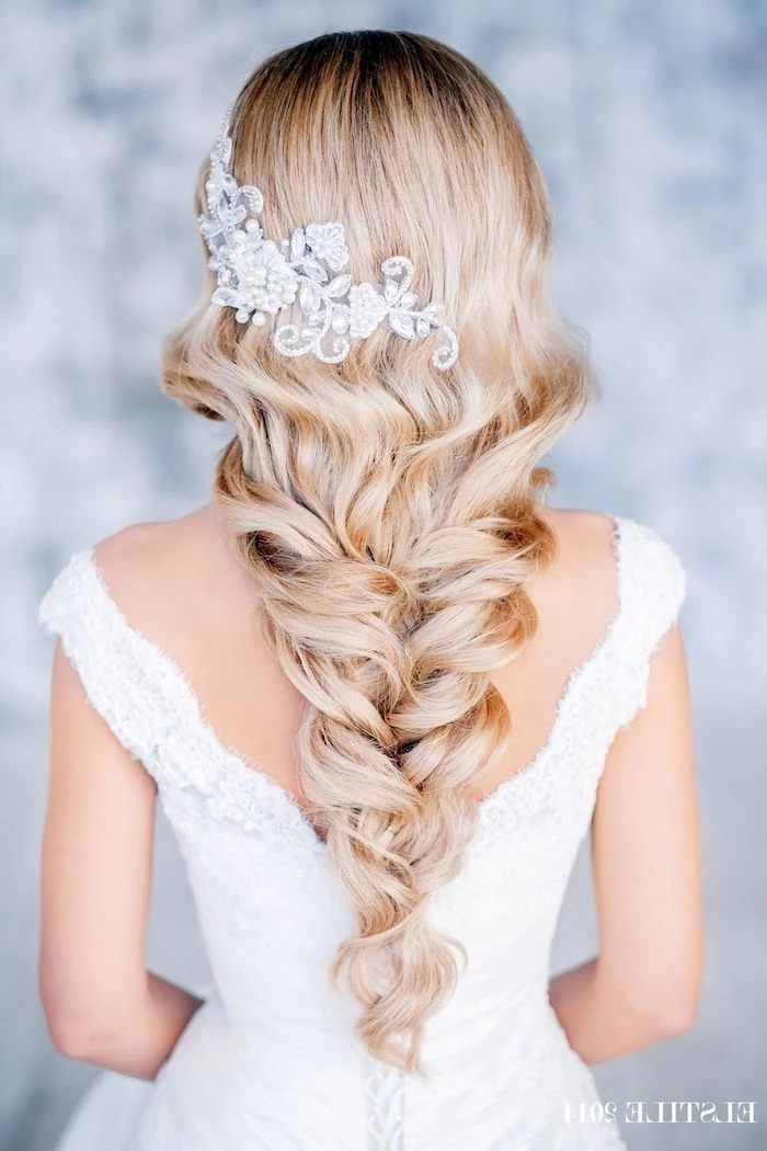 long blonde hair, in a loosely braided ponytail, large hair accessory in hair, wedding hairstyles for long hair