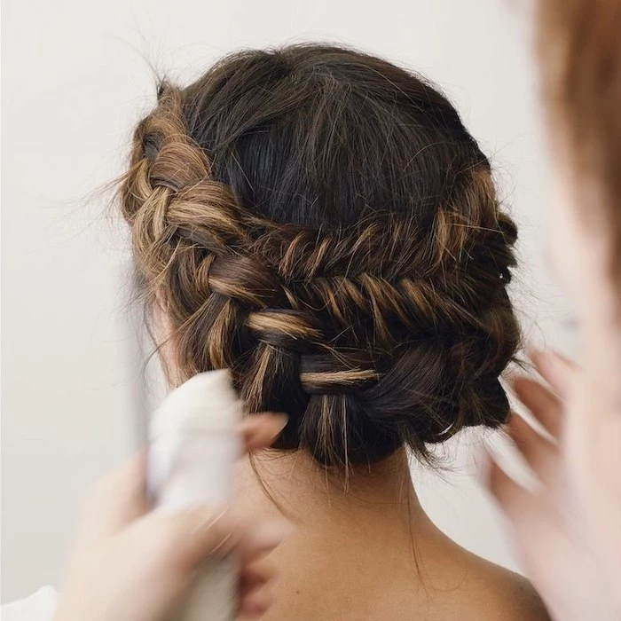 brown hair with highlights, in a braided low updo, wedding hairstyles for long hair, set of hands