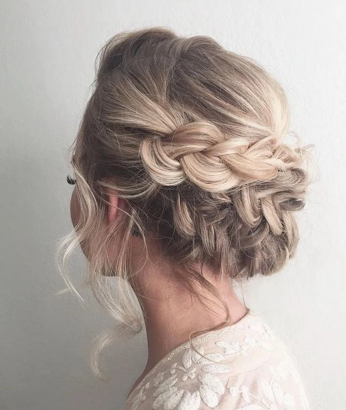 wedding hairstyles updo, blonde hair, braided low updo, white dress, white background