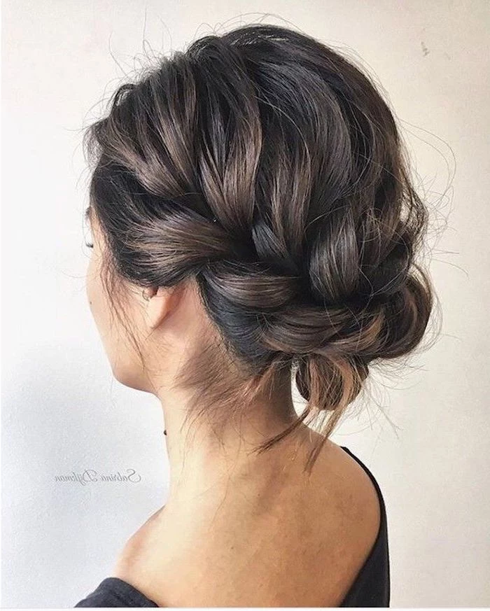 white background, wedding hairstyles updo, brown hair in a braided updo, black top