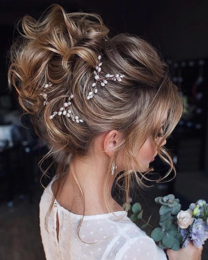 long brown hair with highlights, bridal udos, small pearl accessories, white dress, small flower bouquet