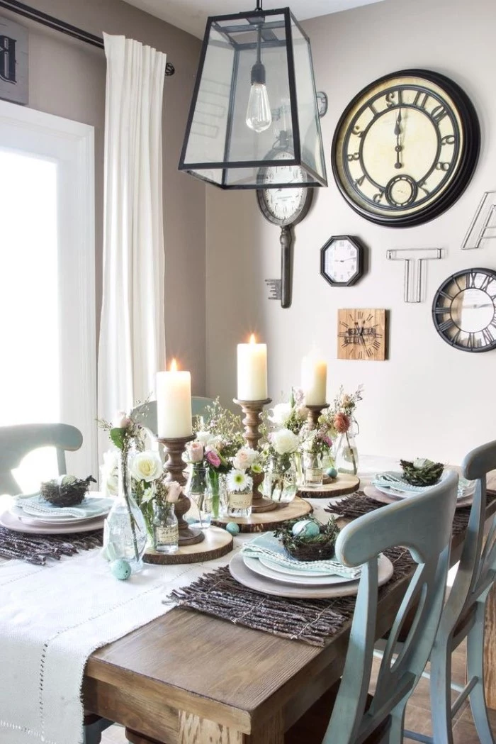 simple table decorations, tall candles, white table runner across the table, bouquets of flowers