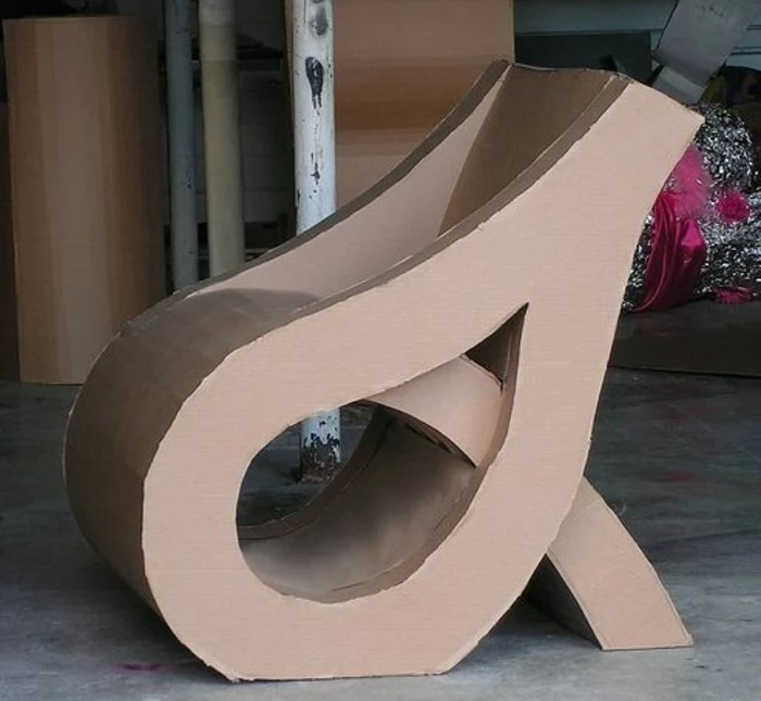 grey cement floor, cardboard chair, intricate design, cardboard dresser