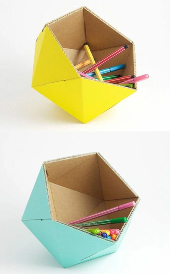 cardboard table, cardboard pencil holders, painted in yellow and turquoise, full of pens and pencils