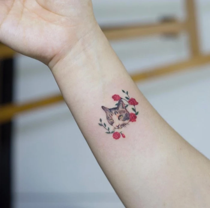 cat and red roses wrist tattoo, small tattoos for women, blurred background