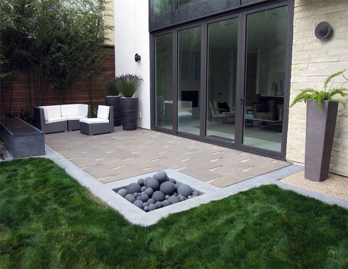 patch of grass, around a cement tiled floor, garden decoration ideas, garden furniture, potted plants