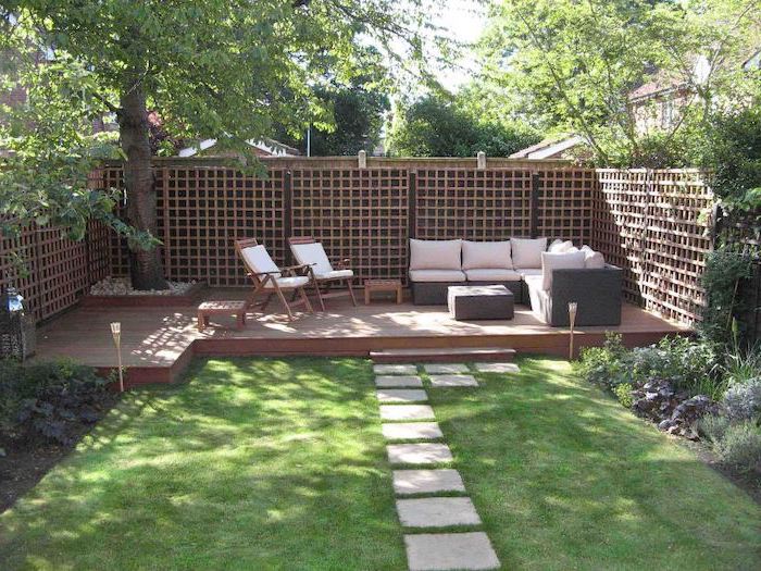 cement tiled pathway, on a patch of grass, leading to the garden furniture, garden decoration ideas