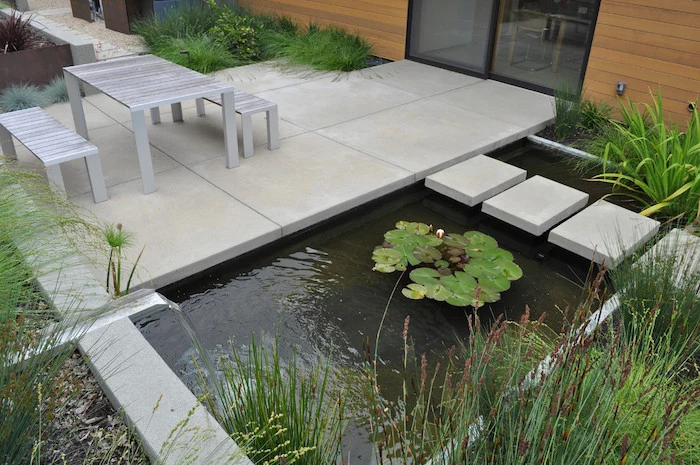 cement tiles, over a small pond, small backyard landscaping ideas, small garden furniture, planted bushes around