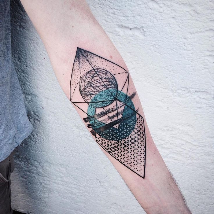 Geometric arm tattooed by Manu