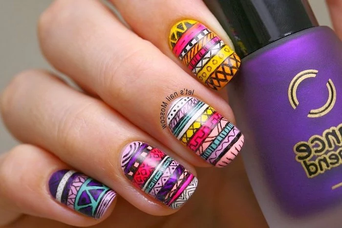 colourful patterned manicure, purple nail polish bottle, simple nail designs, hand holding the bottle