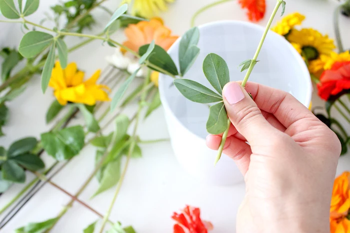 small white vase, lots of colourful flowers, on a white countertop, flower centerpieces, diy tutorial