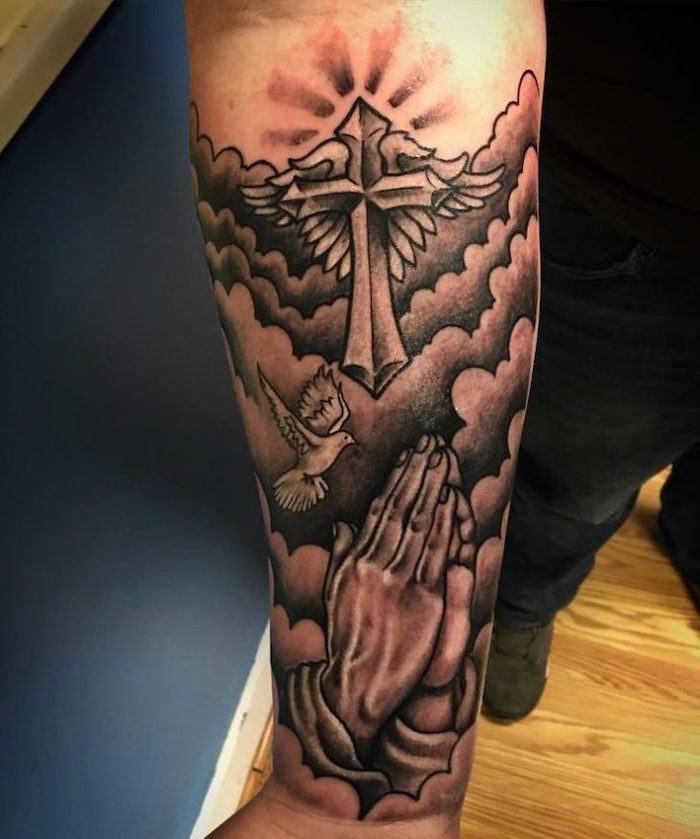 praying hands, sleeve tattoos for men, religious theme, forearm tattoo, blue background