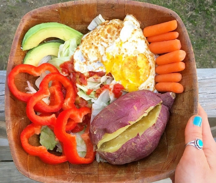 wooden bowl, full of eggs, peppers and red potato, baby carrots and avocado, diets for women