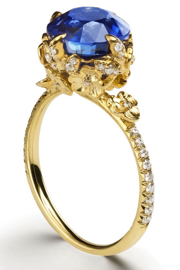 large sapphire, golden diamond studded band, white background, unique wedding rings