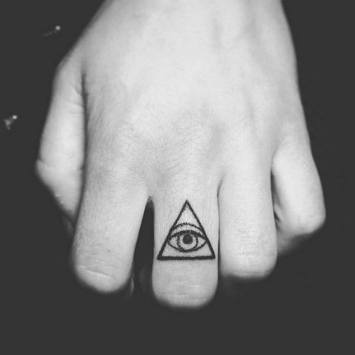 eye inside a triangle, middle finger tattoo, on a black background, finger tattoos
