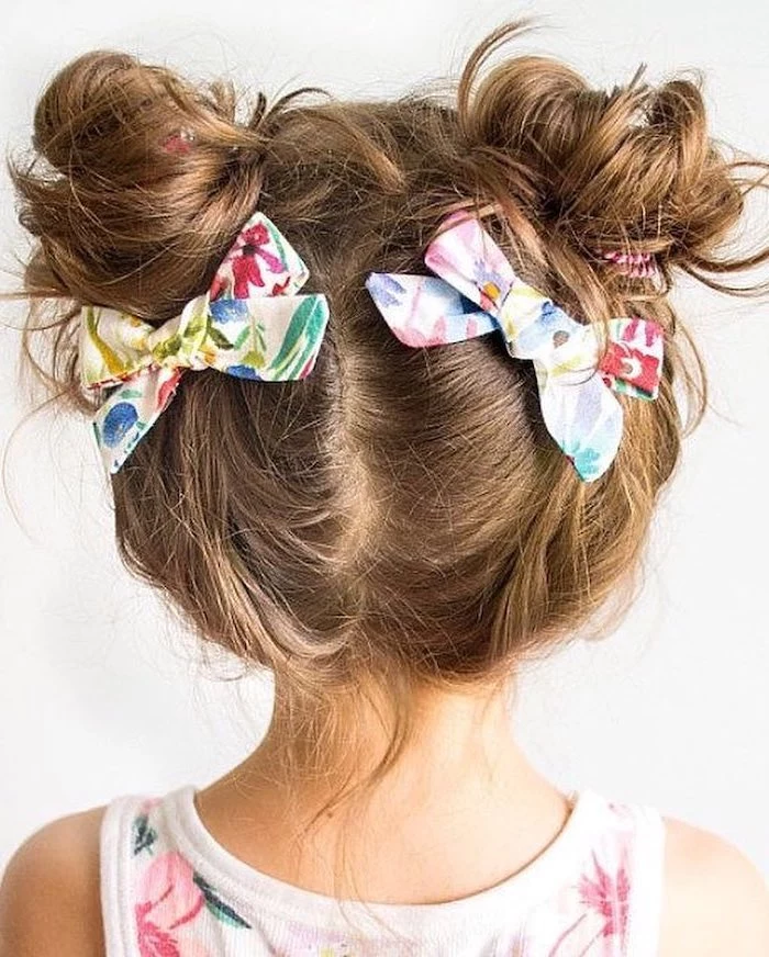 floral bows, two messy buns, brown hair, floral top, cute hairstyles for girls, white background