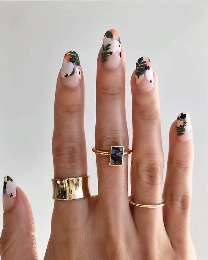 three golden rings on the finger, long almond shaped nails, nail design ideas, floral manicure