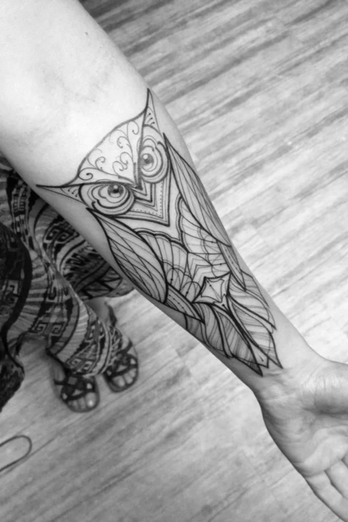 balance tattoo, large geometrical owl, tattooed on the forearm, girl with skirt and sandals