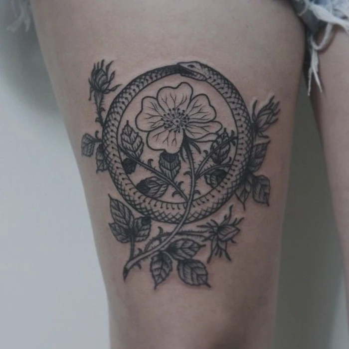 flower with thorns, snake eating itself, balance tattoo, on the girl's thigh